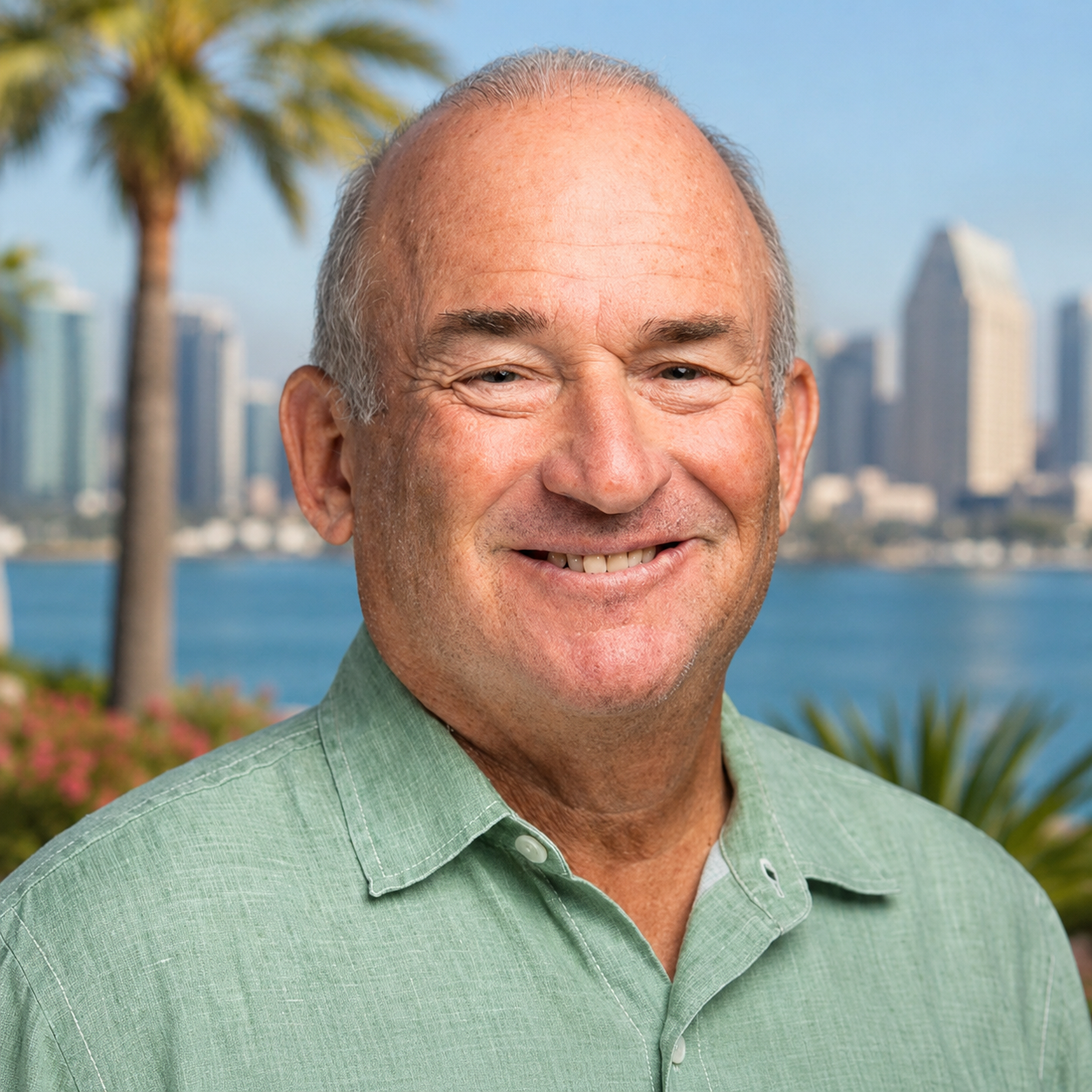 Dr. Jay Berenter, DPM, FACFAS, smiling with the San Diego skyline behind him